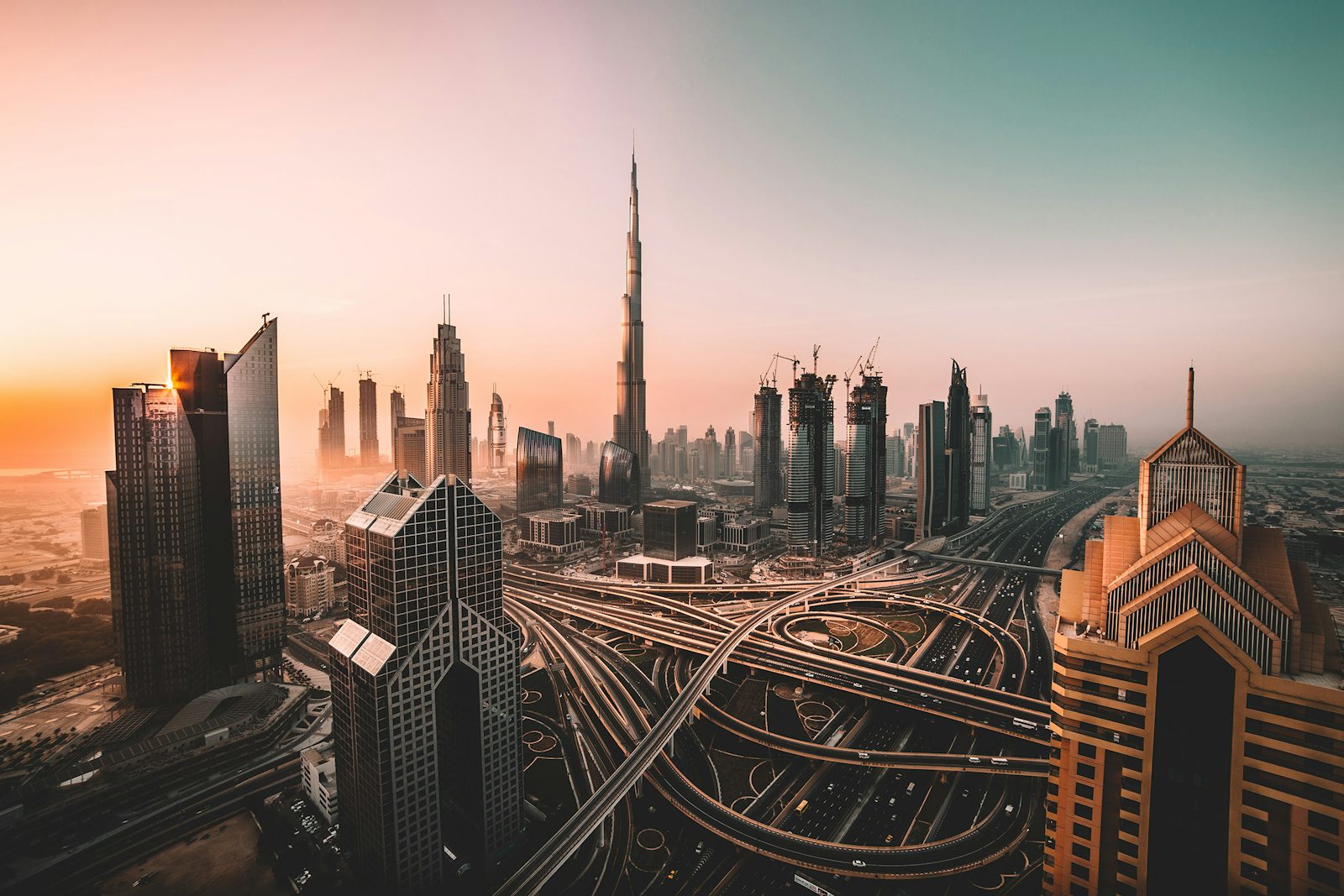 Dubai skyline at sunset, Burj Khalifa above the Sheikh Zayed Road interchange